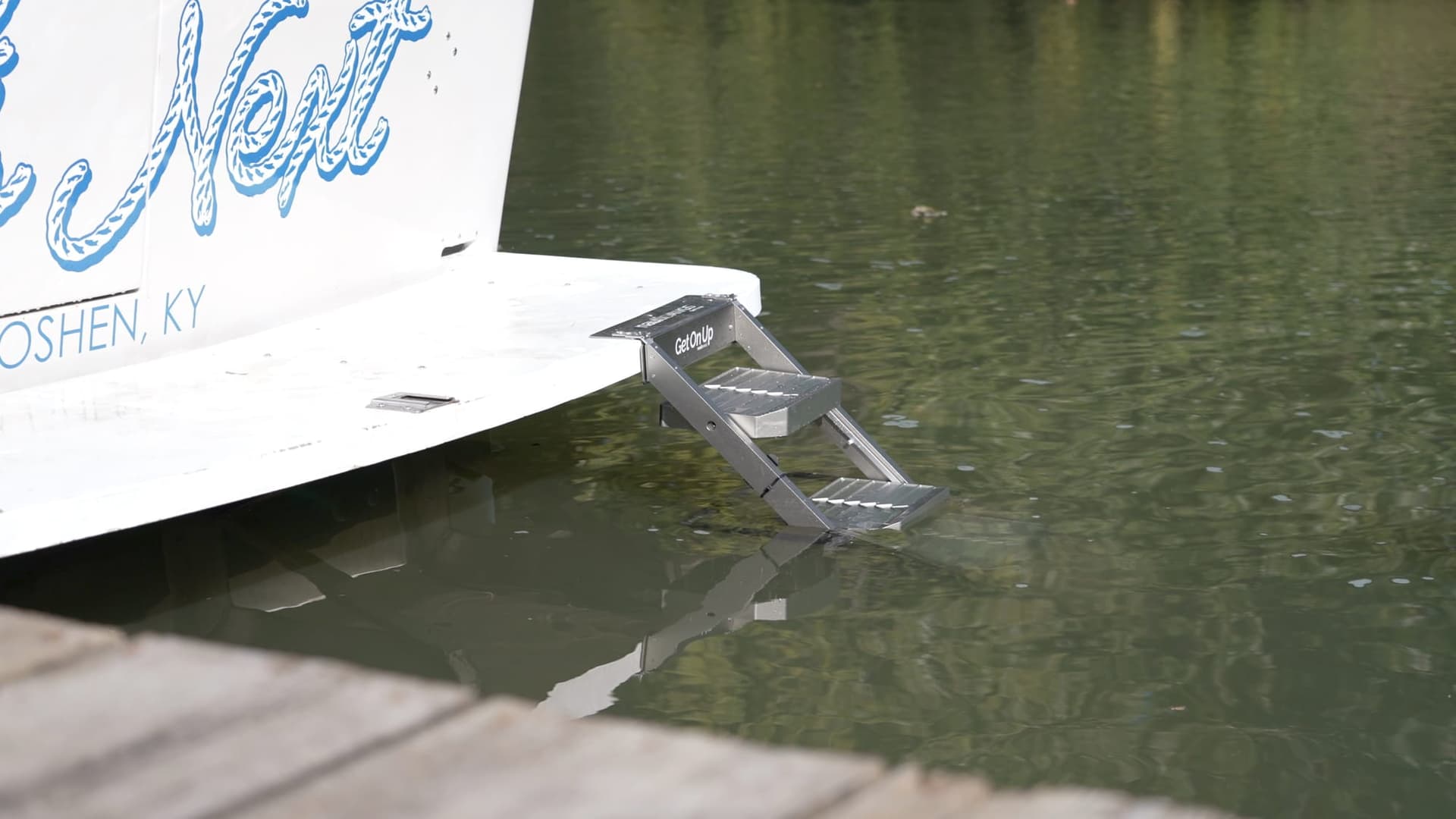 nautiDAWGS ladder mounted to a swim platform, deployed into the water