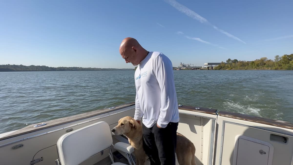 Troy petting Remmy on the swim platform